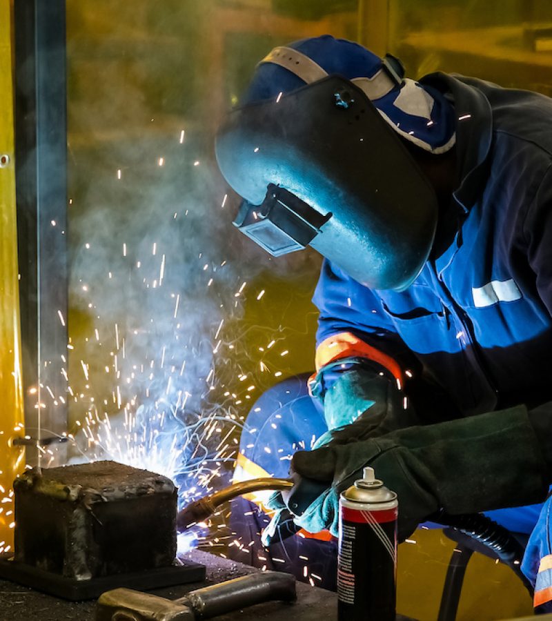 A male working with a welding torch